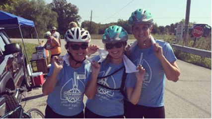 Three Kindred at Home associates at a charity bike ride.