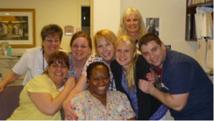A small group of Kindred at Home associates embracing, smiling and enjoying each other’s company.