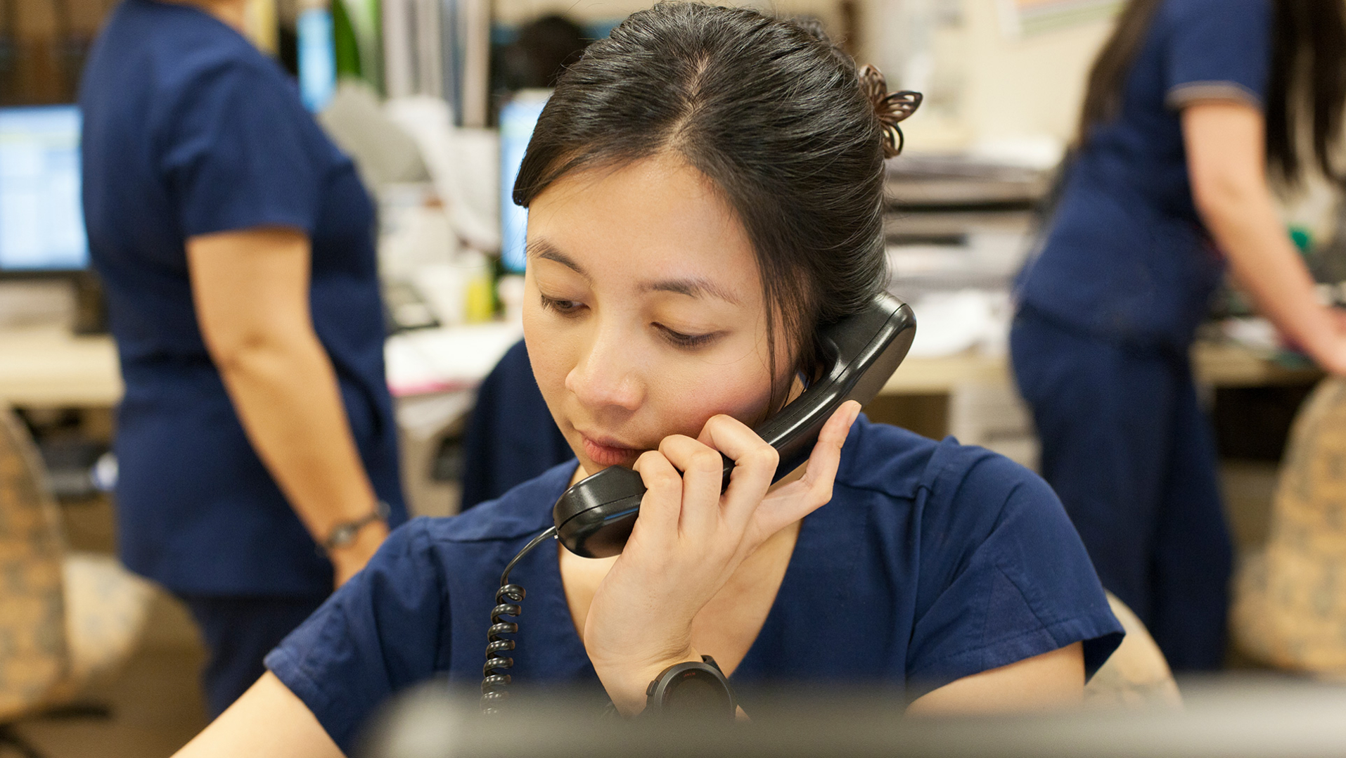 A care team member answering a phone. 